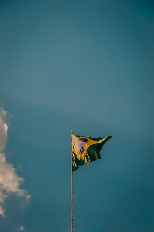 Free Low angle view of the Brazilian flag waving against a clear sky in Indaiatuba, SP, Brazil. Stock Photo
