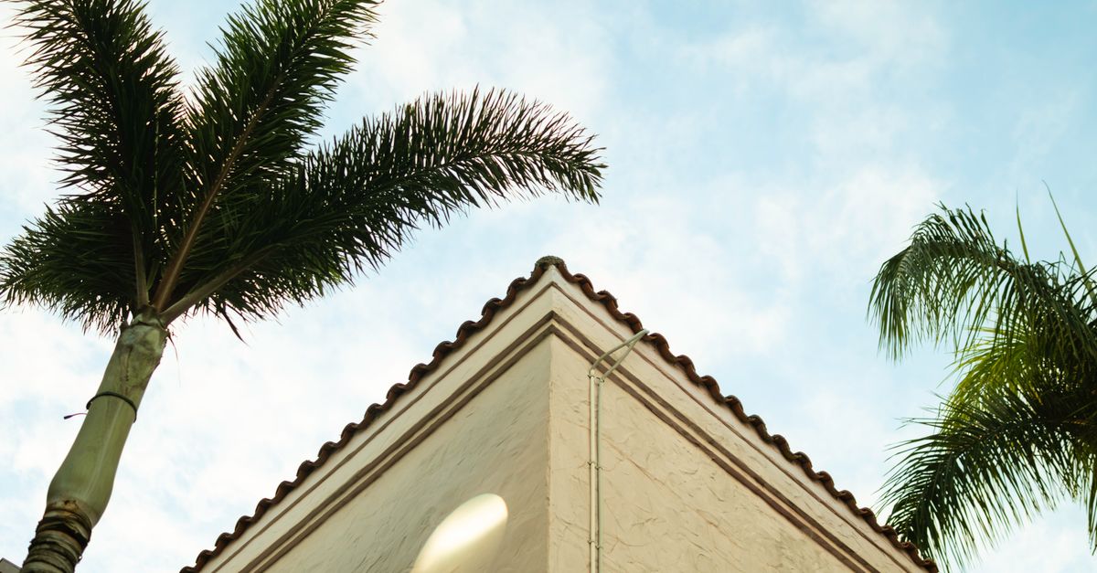 Low angle view of a building corner with palm trees in Gold Coast, Australia.