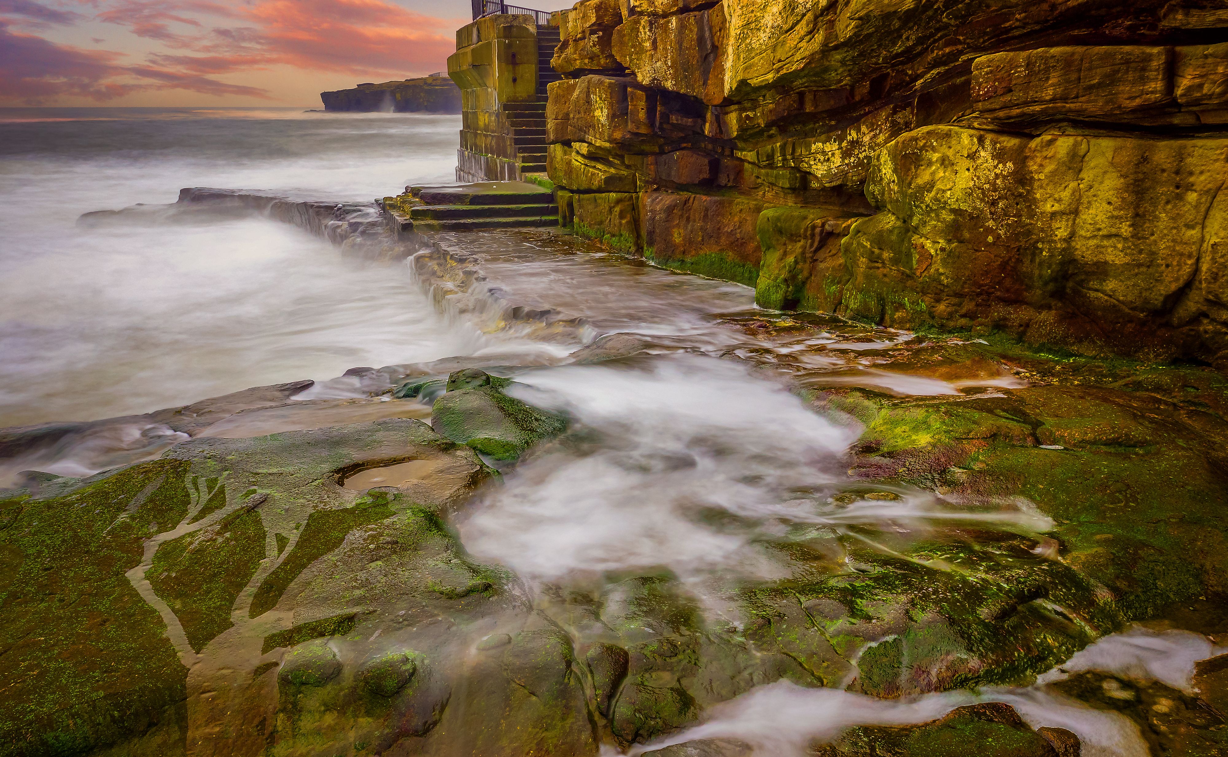 A long exposure photograph of a rocky shoreline · Free Stock Photo
