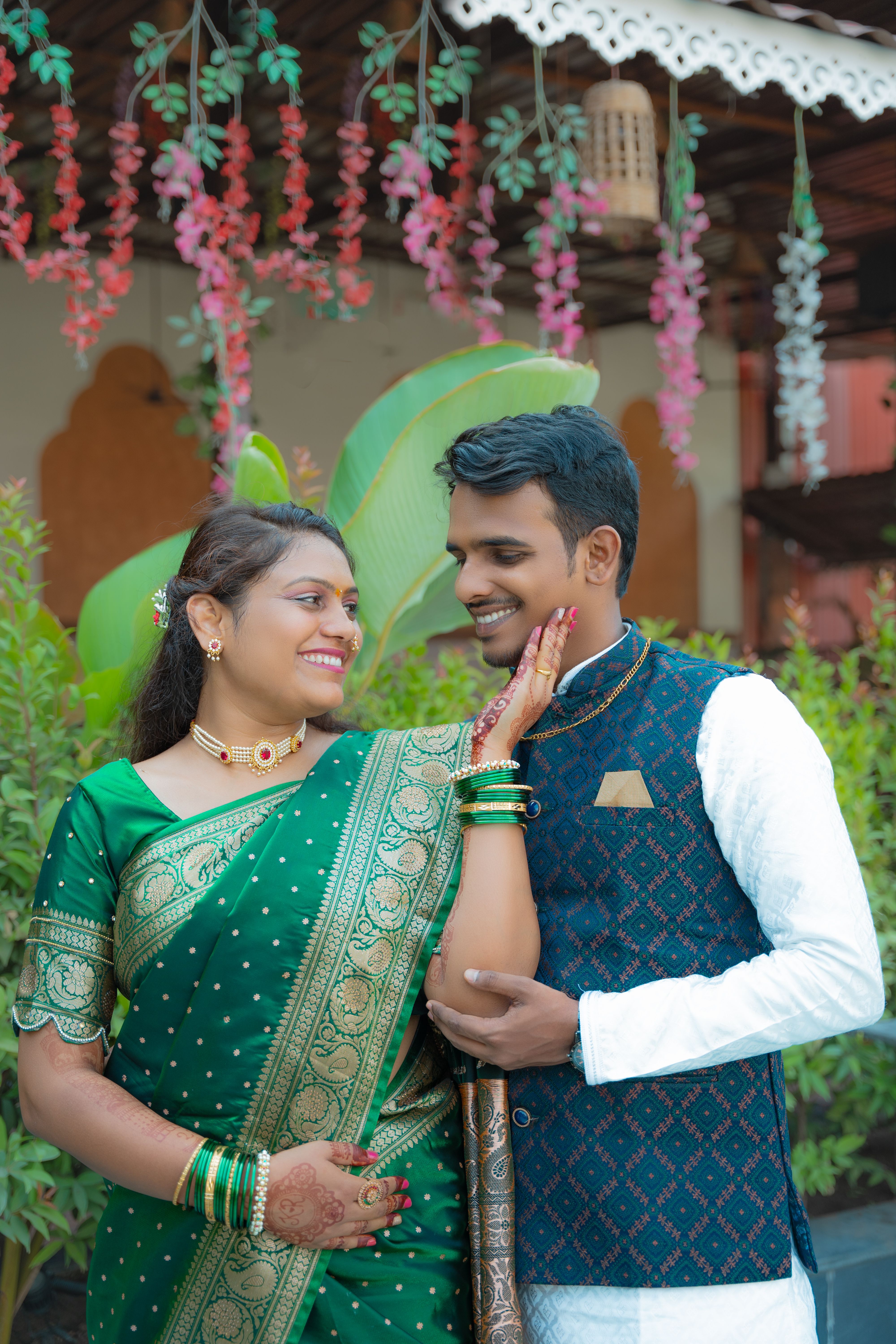A couple in traditional attire posing for a photo · Free Stock Photo