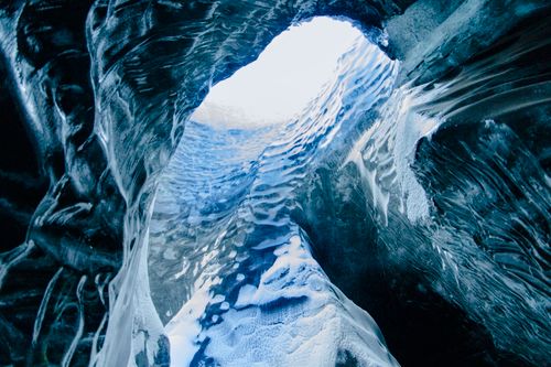 Free Explore the majestic beauty of an ice cave with stunning blue textures and frozen formations. Stock Photo