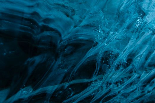 Explore the mesmerizing texture of ice formations in a stunning Icelandic ice cave.
