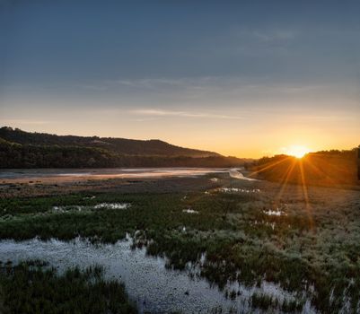 Stunning sunrise over marshland in Weaver, MN with mountains and valleys in view.
