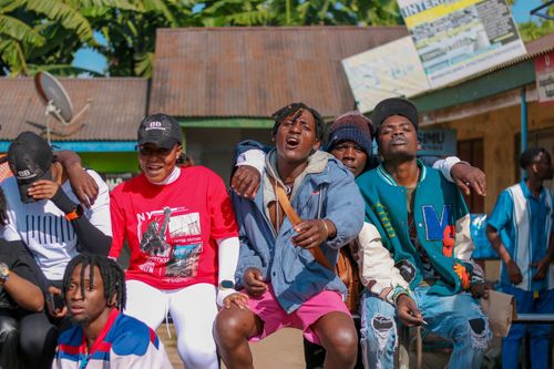 Free A group of young men enjoying a sunny day outdoors, showing camaraderie and fun. Stock Photo