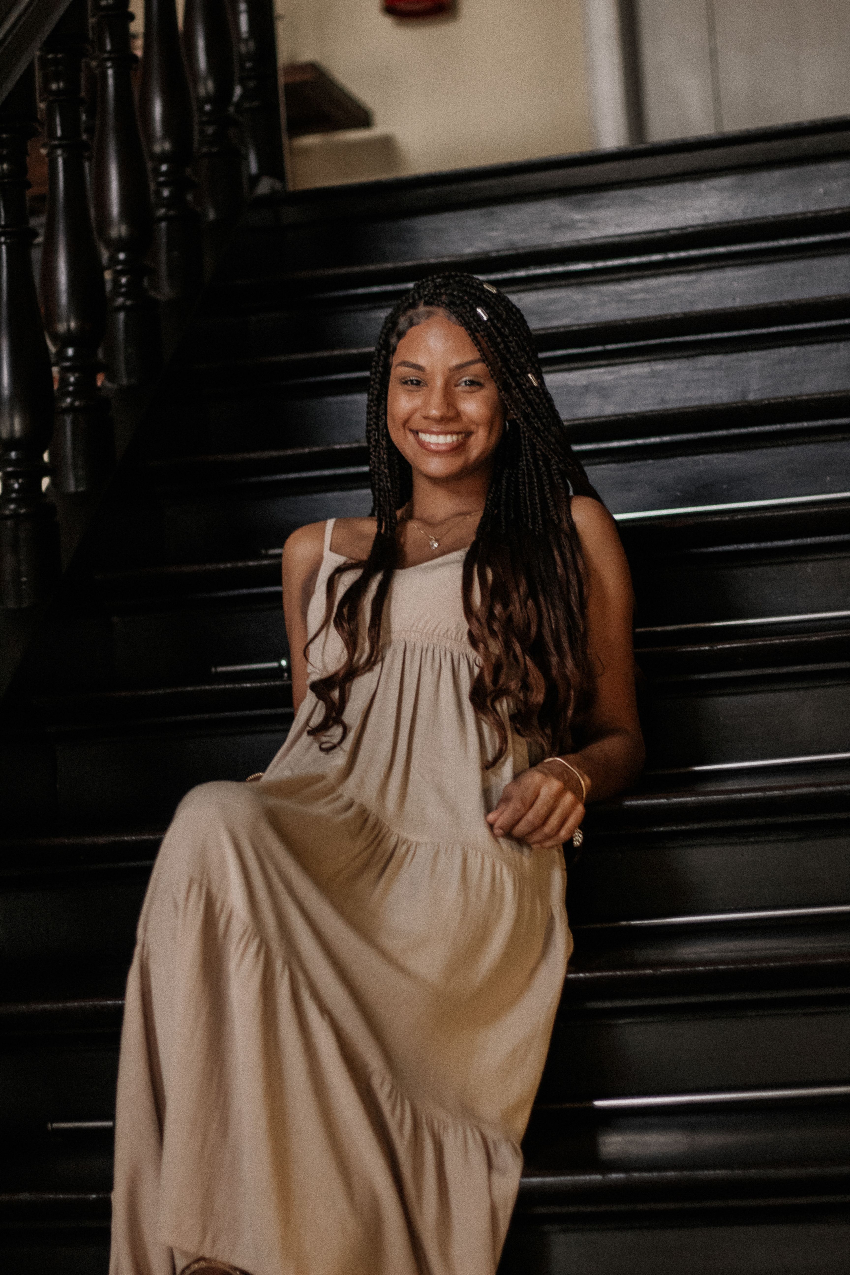 Young Woman in a Beige Dress Sitting on Wooden Stairs · Free Stock Photo