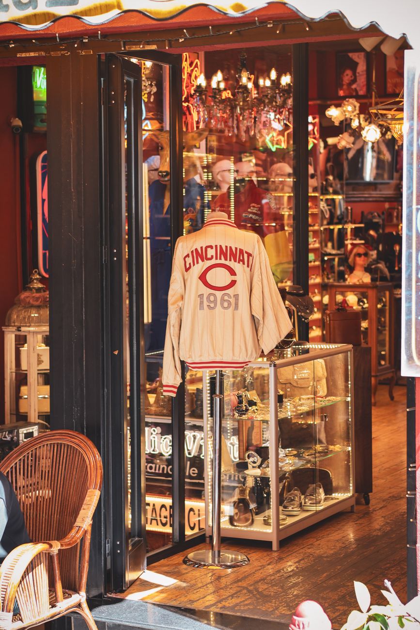 Vintage shop with a Cincinnati 1961 jacket and antique decor displayed.