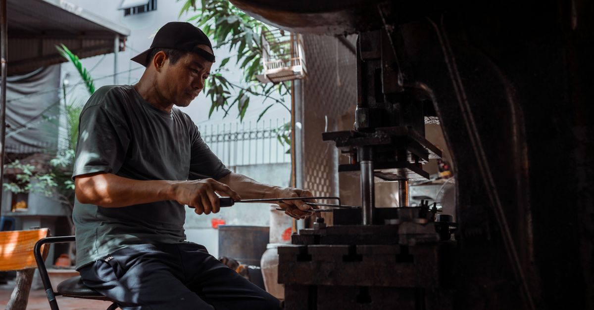 Industrial Worker Operating Heavy Machinery Indoors · Free Stock Photo