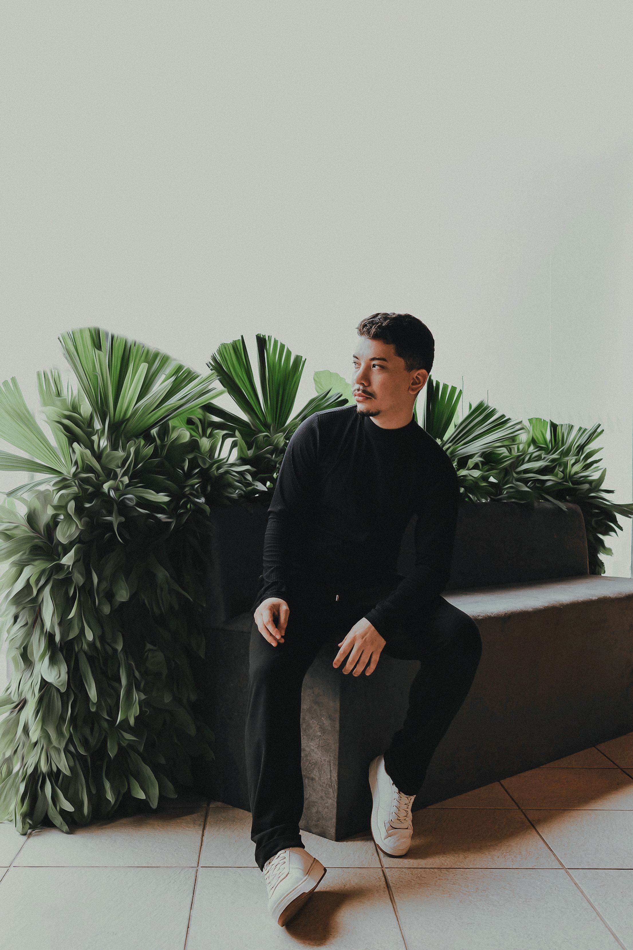 Portrait of a Young Man Wearing Black Clothes Sitting on a Bench · Free ...