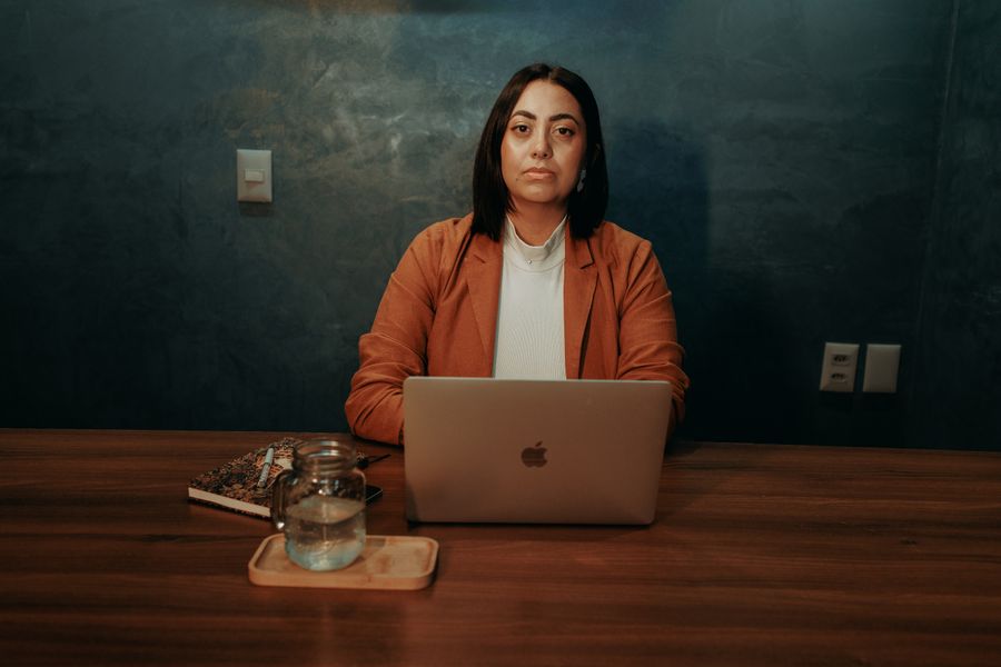 Professional woman working at a laptop in an office