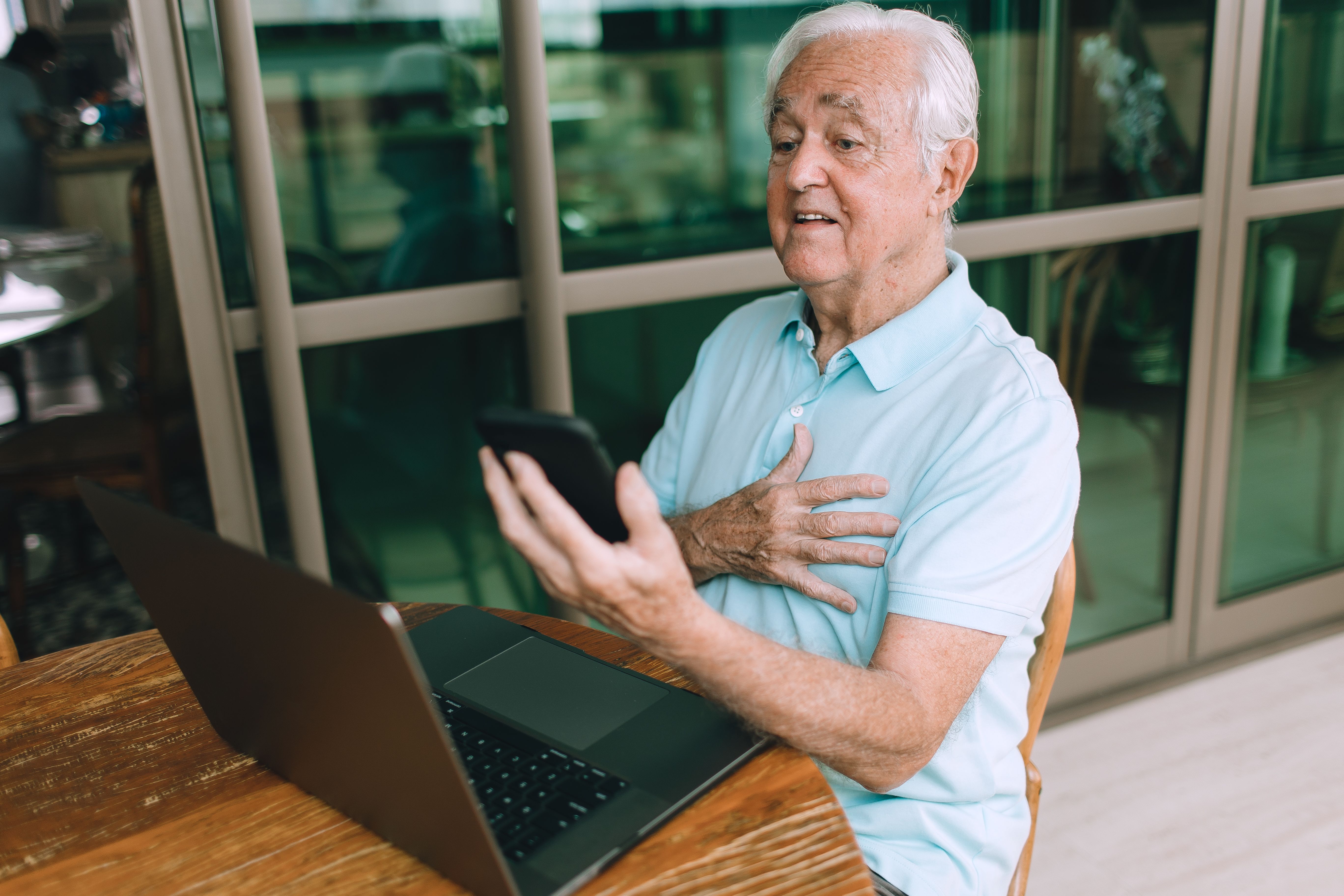A retiree reviewing a 2026 Social Security benefit statement beside a calculator and tax worksheet