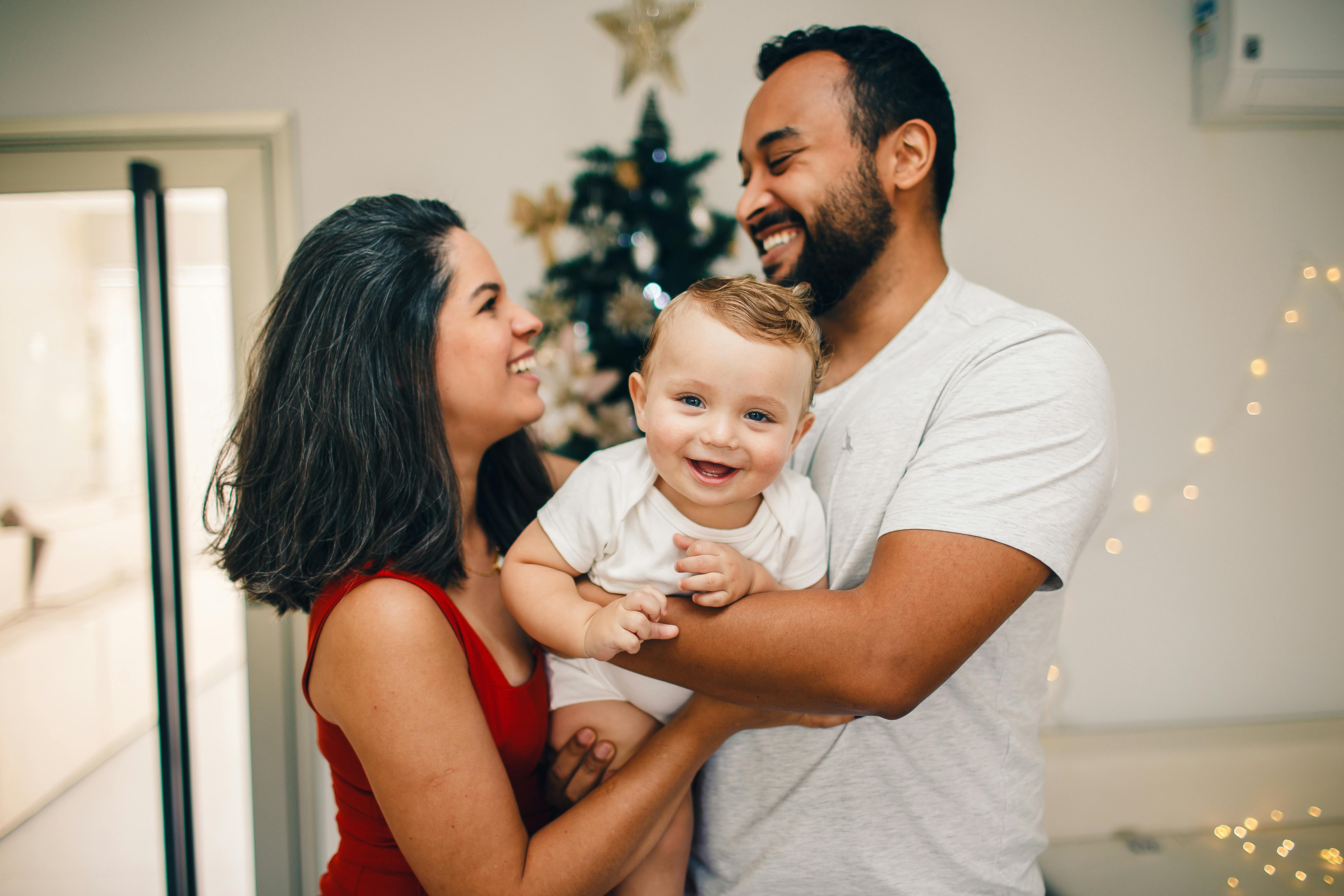 portrait of smiling couple with baby