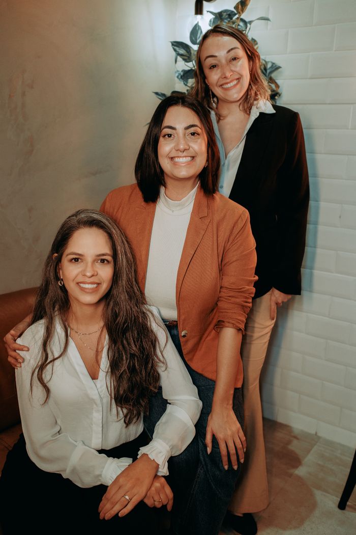 Two teammates standing together in the office — Helena Lopes on Pexels