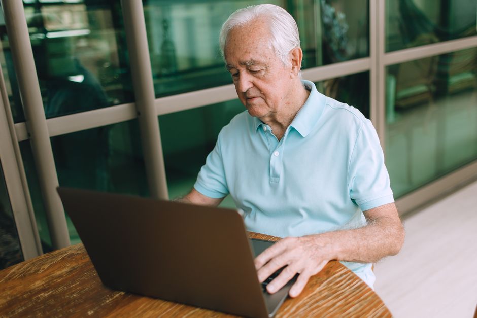 man using laptop comparing insurance quotes online