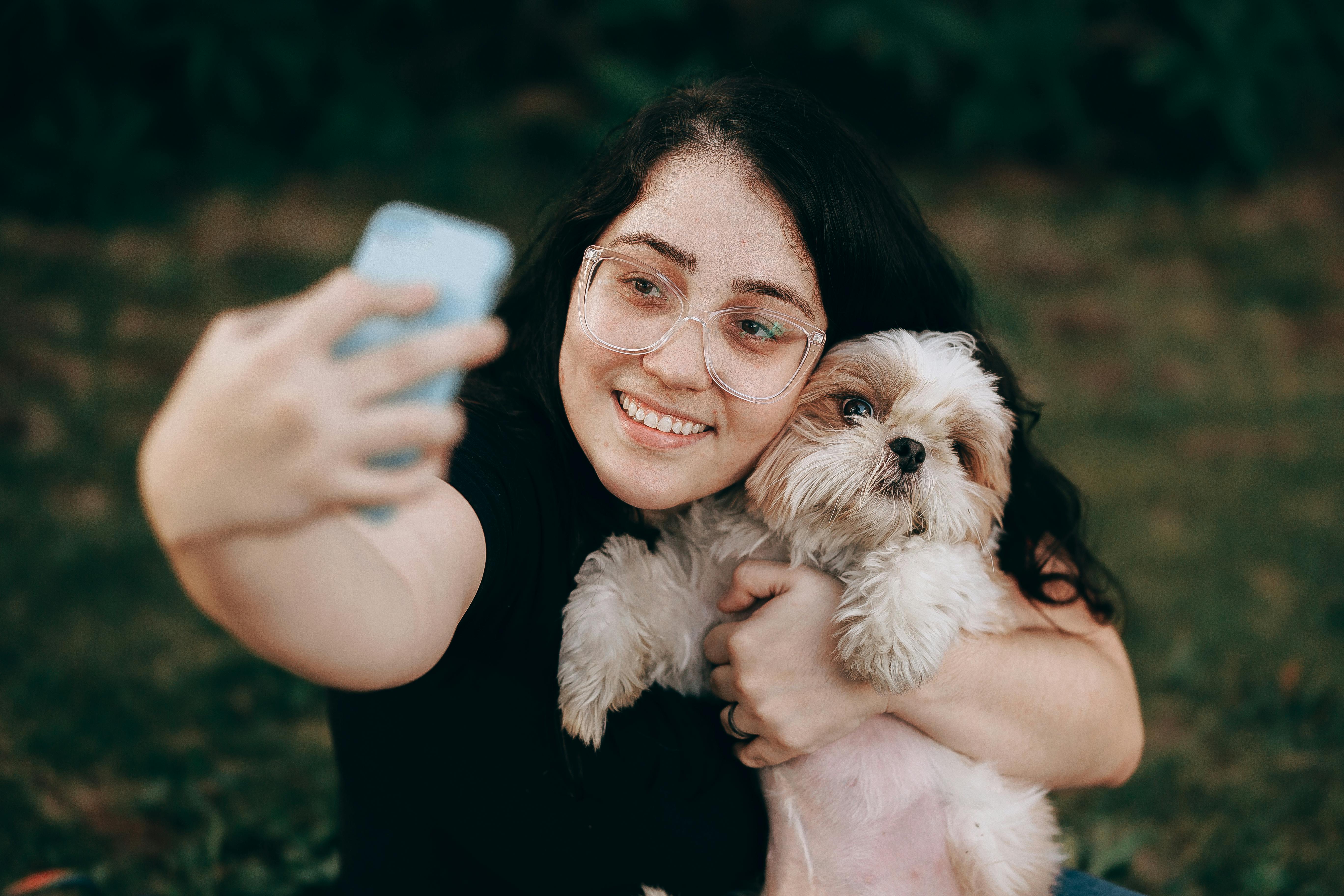 A woman taking a selfie with her dog