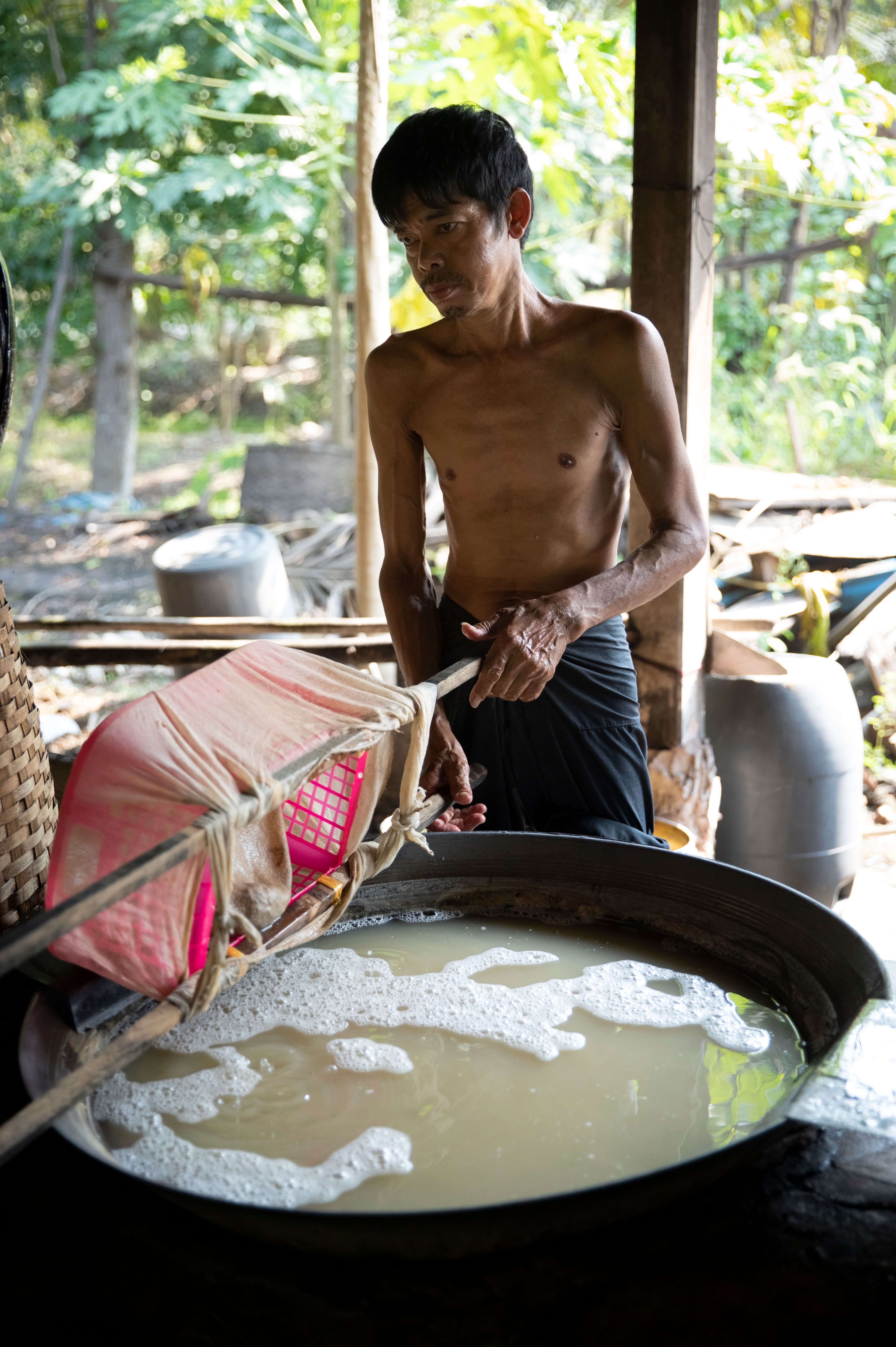 Shirtless Man Preparing Something in Large Bowl · Free Stock Photo