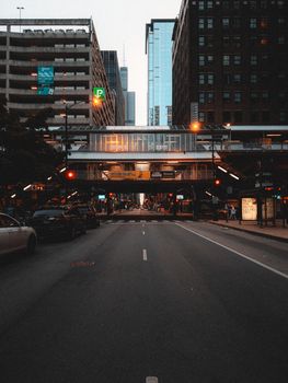 Captivating urban scene featuring elevated train track and skyscrapers at twilight.