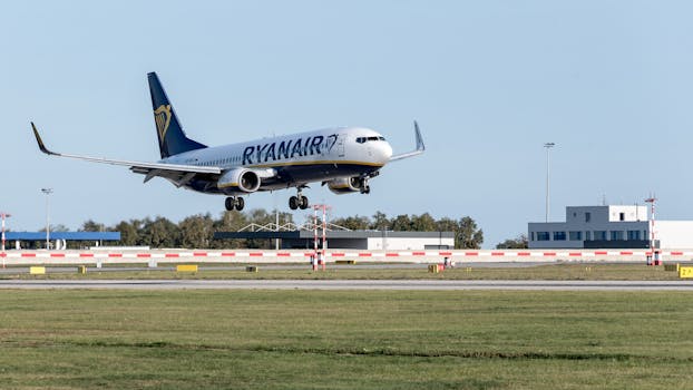 Ryanair aircraft making a smooth landing on a sunny day at Prague airport.