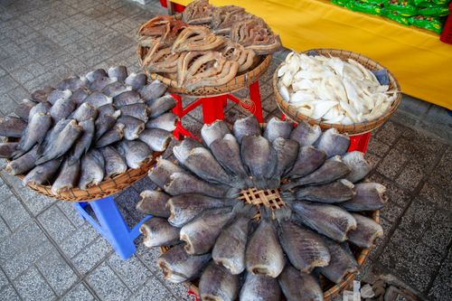 Free Various types of dried fish on display at an outdoor marketplace. Stock Photo