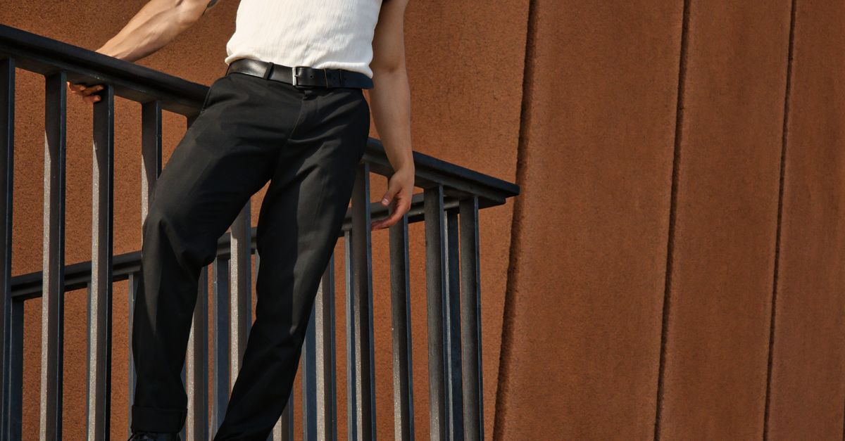 Man in Tank Top Standing behind Railing · Free Stock Photo