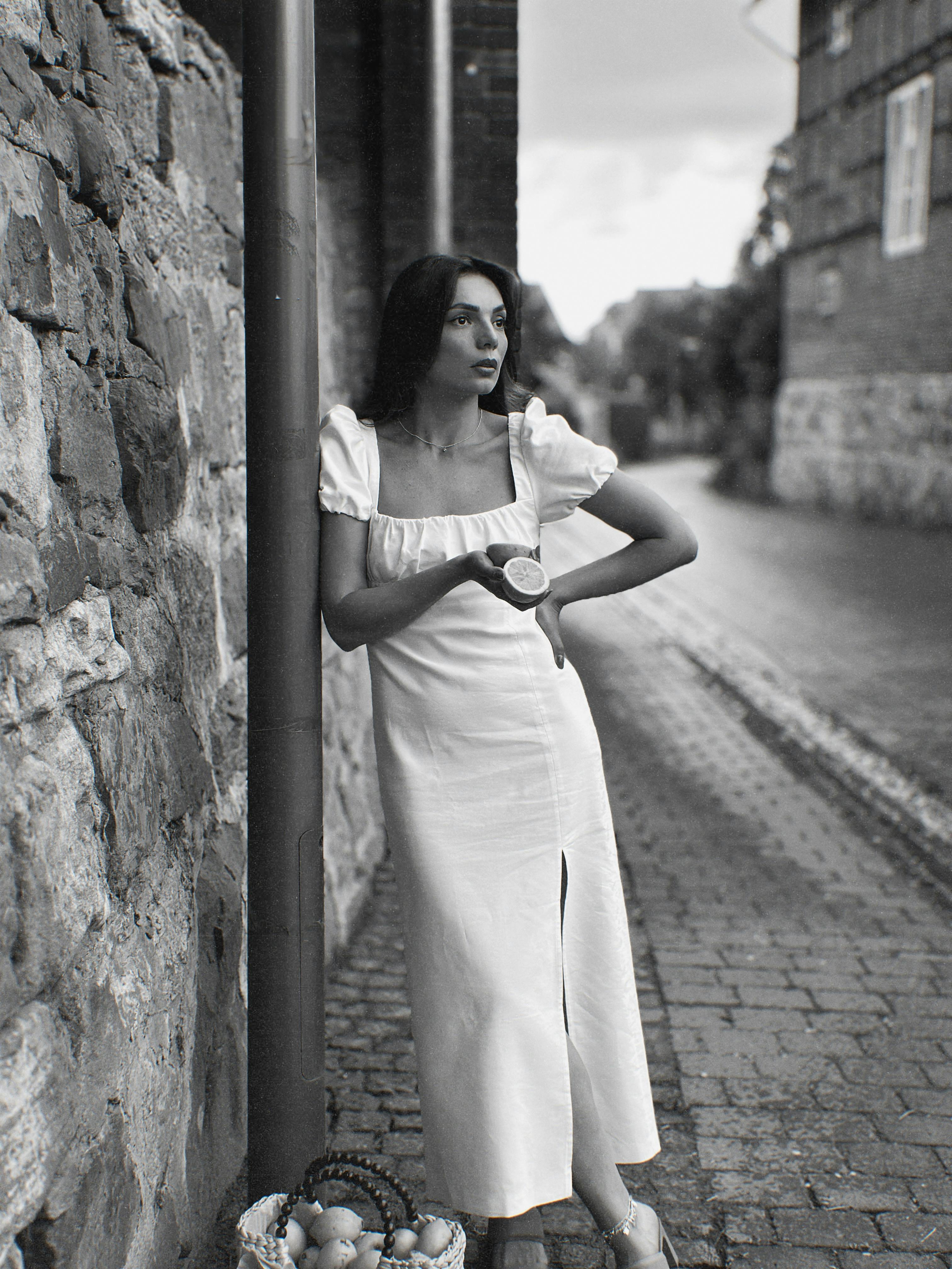 Woman in white dress on a cobblestone street on the French Riviera