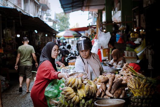 A vibrant street market in Pontianak, Kalimantan Barat, Indonesia with local fruit vendors and diverse people.