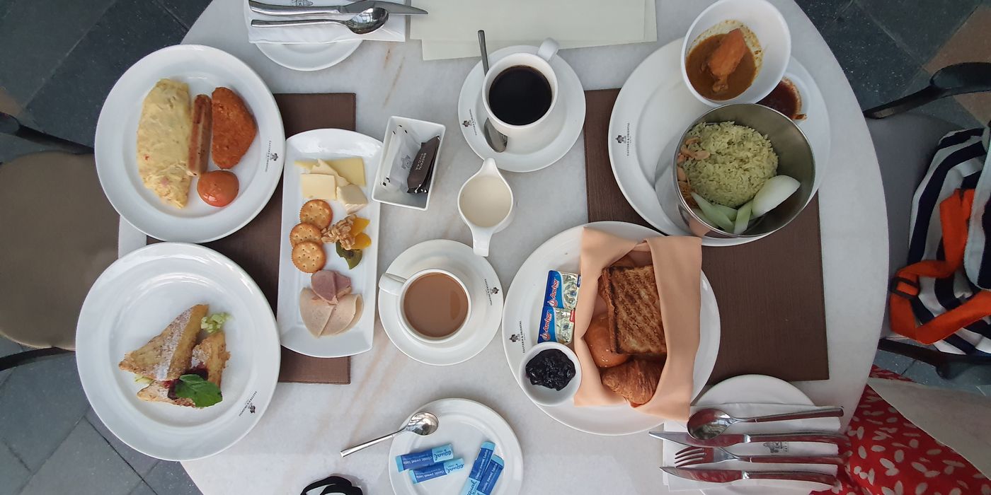 Top-down view of a hotel breakfast spread on a wooden table