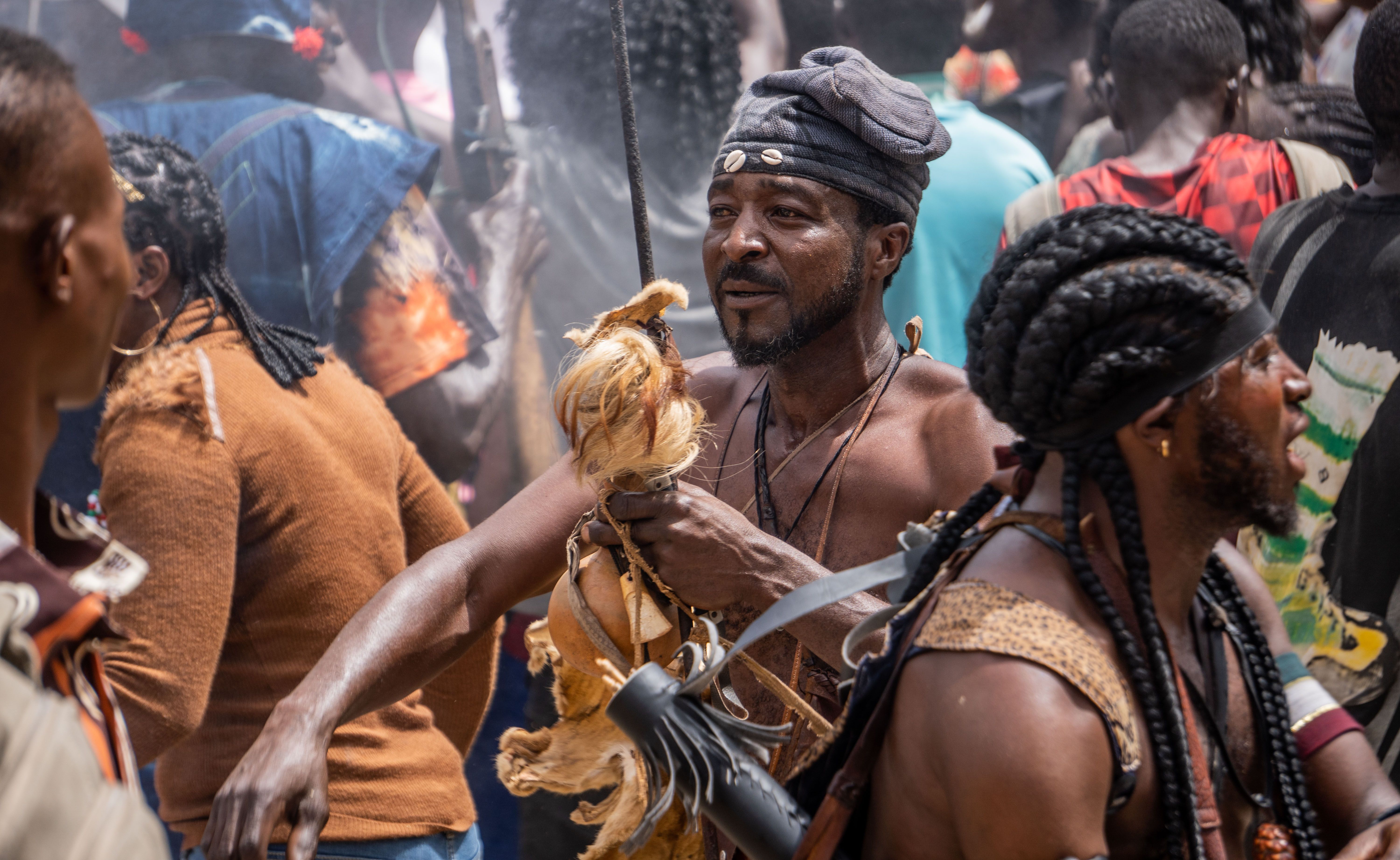 A lively street festival showcasing African culture through music and traditional attire.