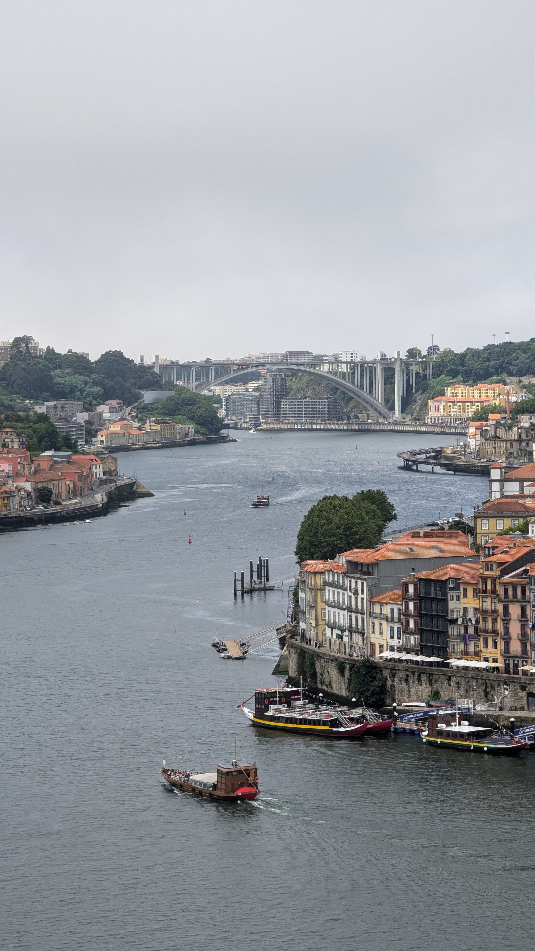 Explore the picturesque view of Porto's cityscape with the Douro River flowing through iconic landmarks.