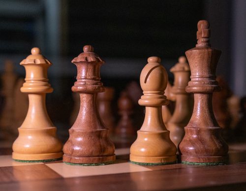 Free Close-up of wooden chess pieces on a chessboard, showcasing strategic focus. Stock Photo