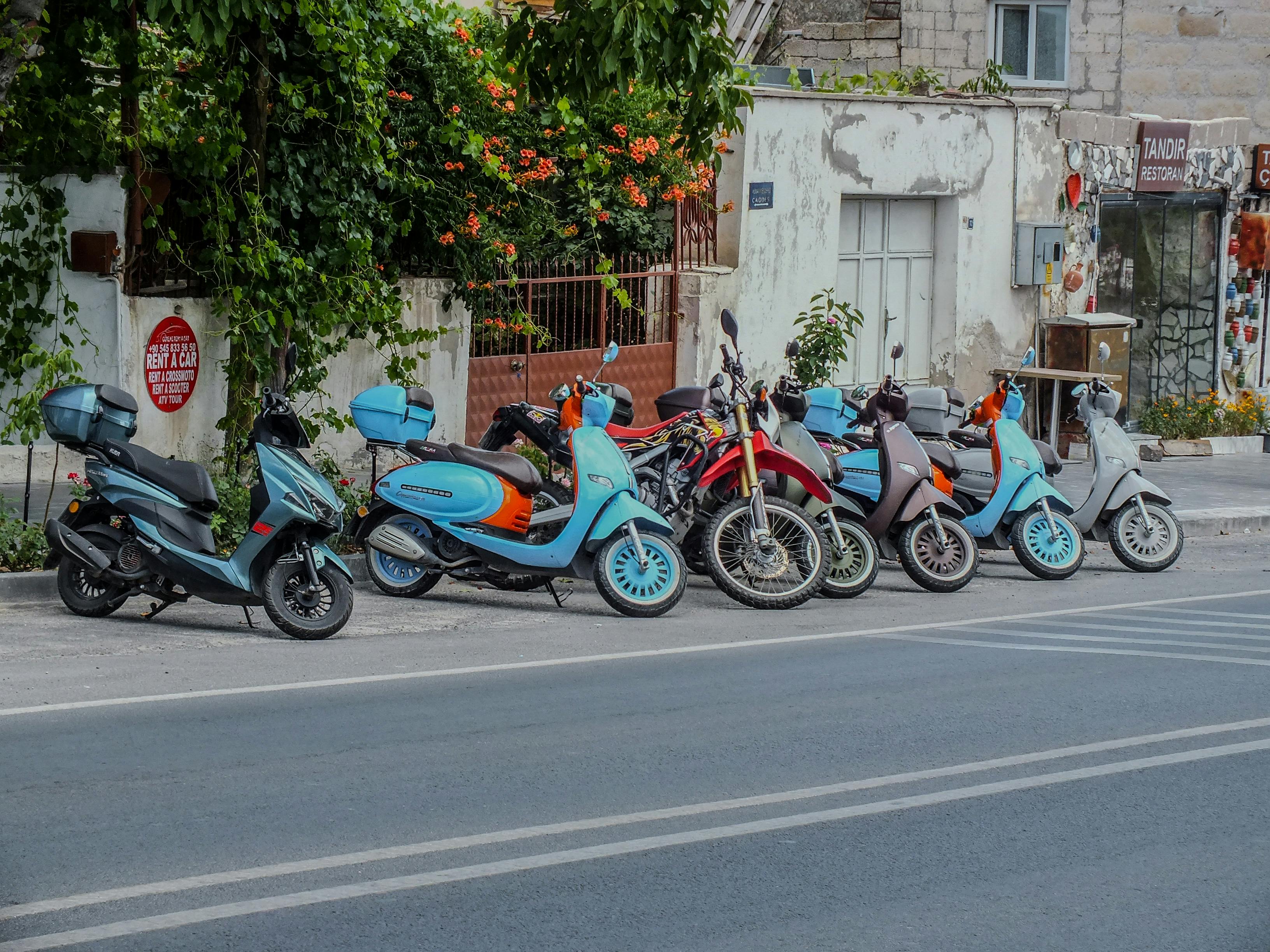 a row of motorcycles parked on the side of the road