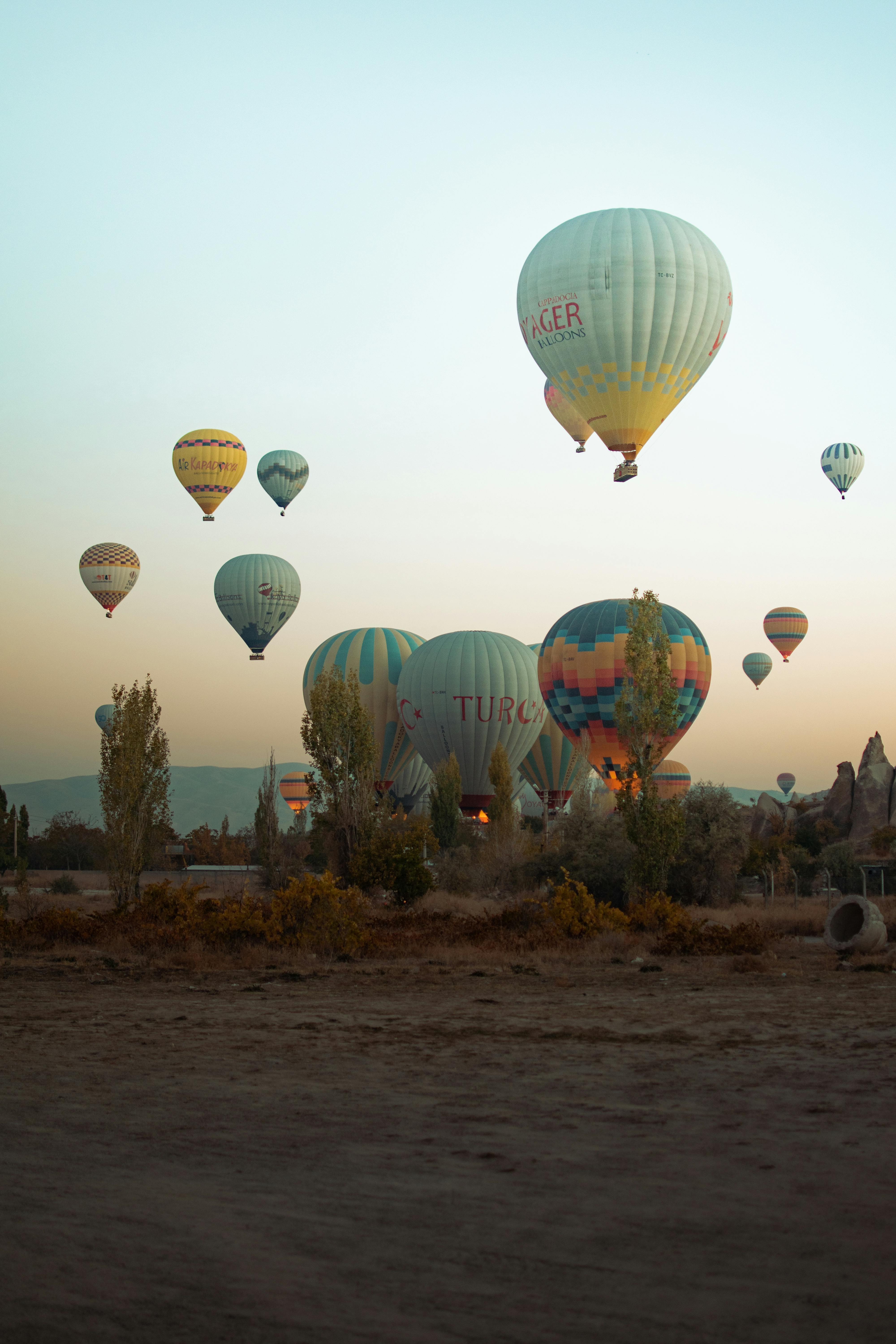 view of colorful hot air balloons flying at sunset