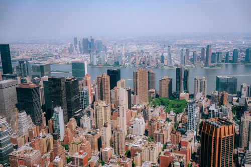 Free Stunning aerial view of New York City's skyline with iconic skyscrapers and river view. Stock Photo