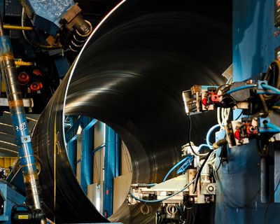 Industrial press forming metal in a fabrication facility