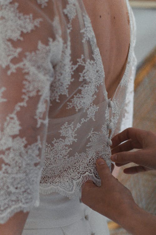 Free A woman is putting on a wedding dress Stock Photo