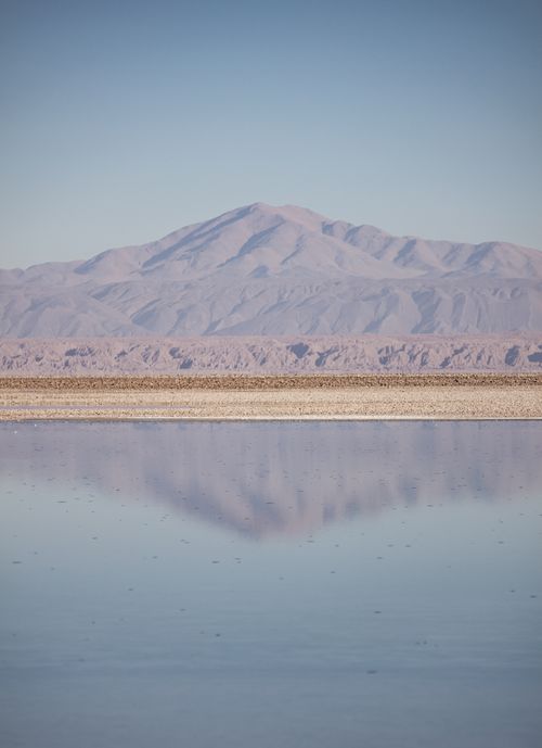 Free Peaceful landscape of Atacama mountain range reflecting on a tranquil lake under clear skies. Stock Photo