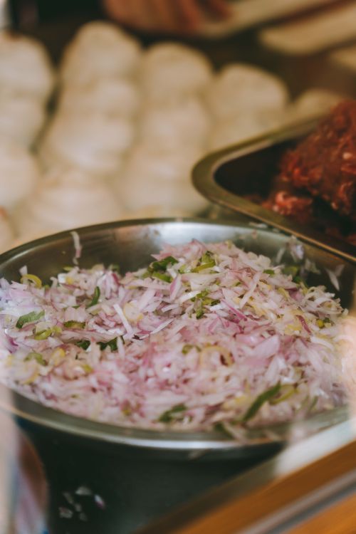 Free Close-up of chopped onions in a Kuala Lumpur restaurant, ideal for culinary and food photography. Stock Photo