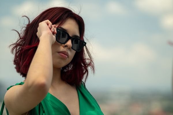 Portrait of a woman with red hair in dark sunglasses outdoors — photo by Israyosoy S. on Pexels