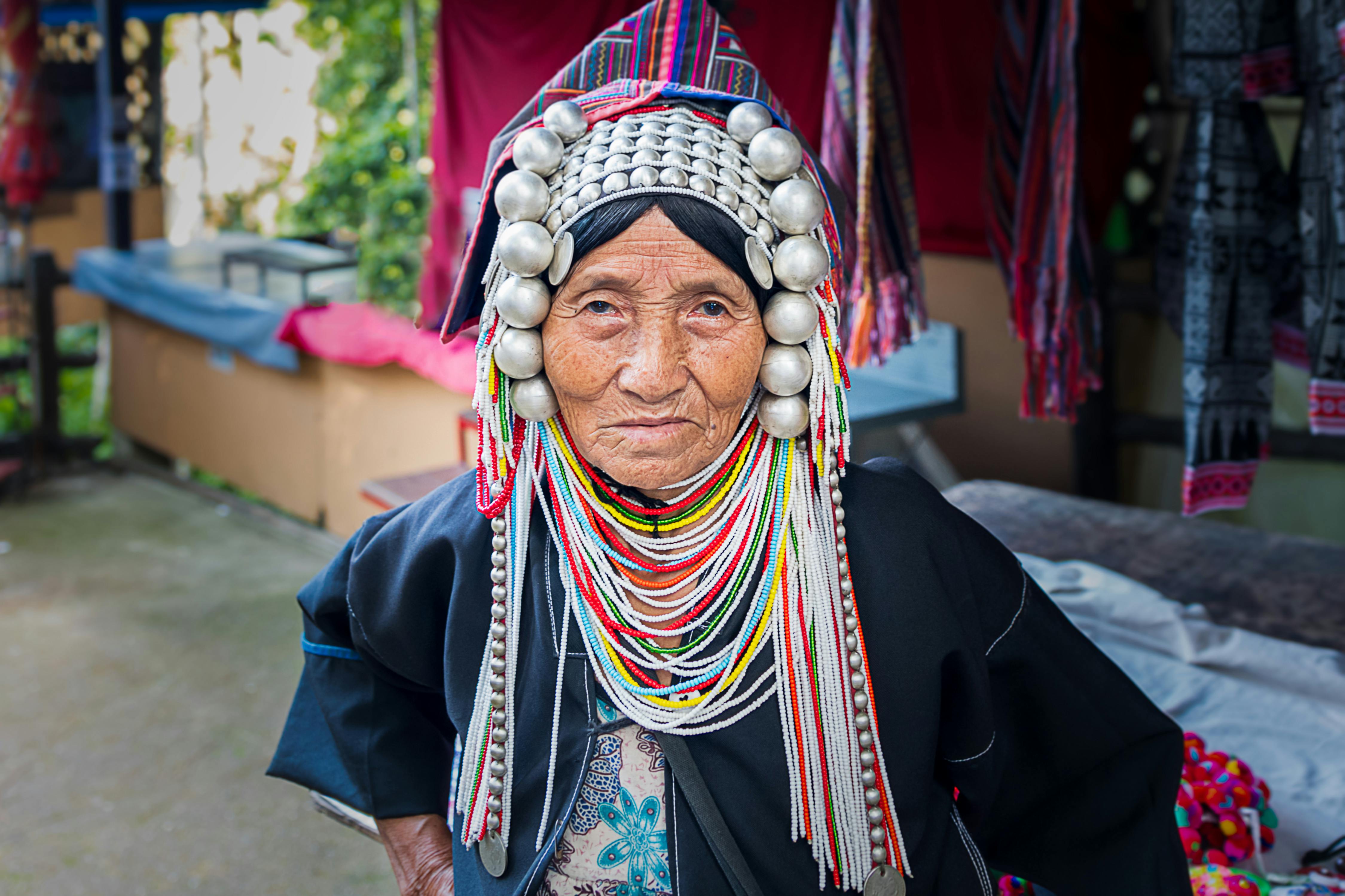 Portrait of an Akha woman in traditional attire at Mueang Chiang Rai, Thailand.