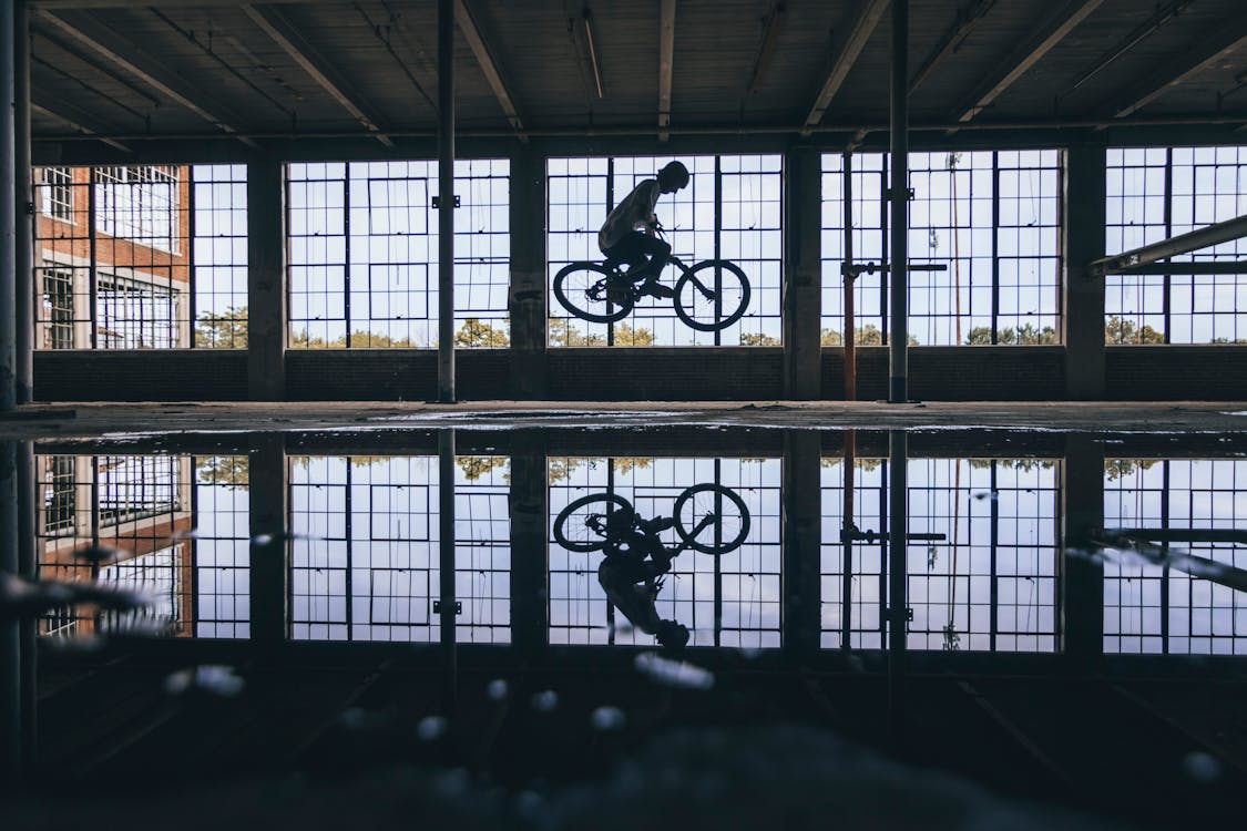 Free Person Riding A Bicycle Inside the Building Stock Photo