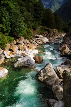 Stunning view of Verzasca River with clear waters and rugged rocks in Switzerland's lush landscape.