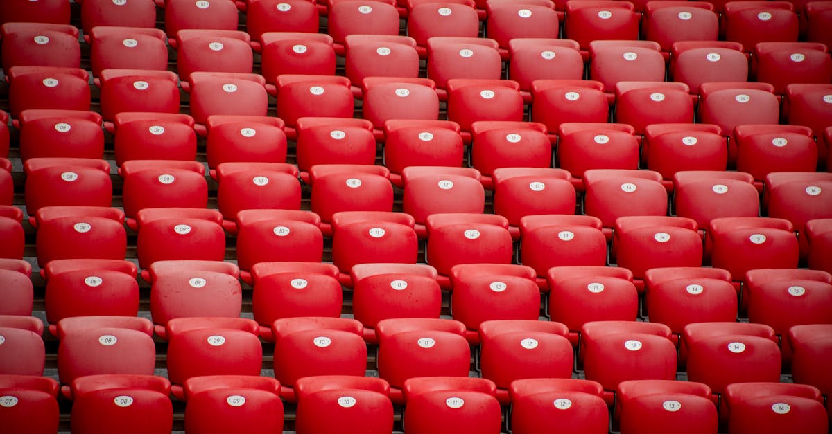 Empty red stadium seats in symmetrical arrangement at San Mames stadium in Bilbao, Spain.