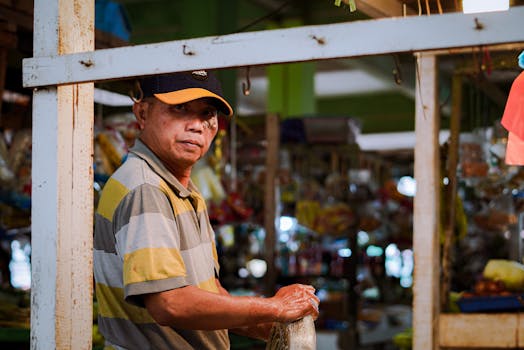 Man working at a bustling local market stall in Pontianak, Indonesia.