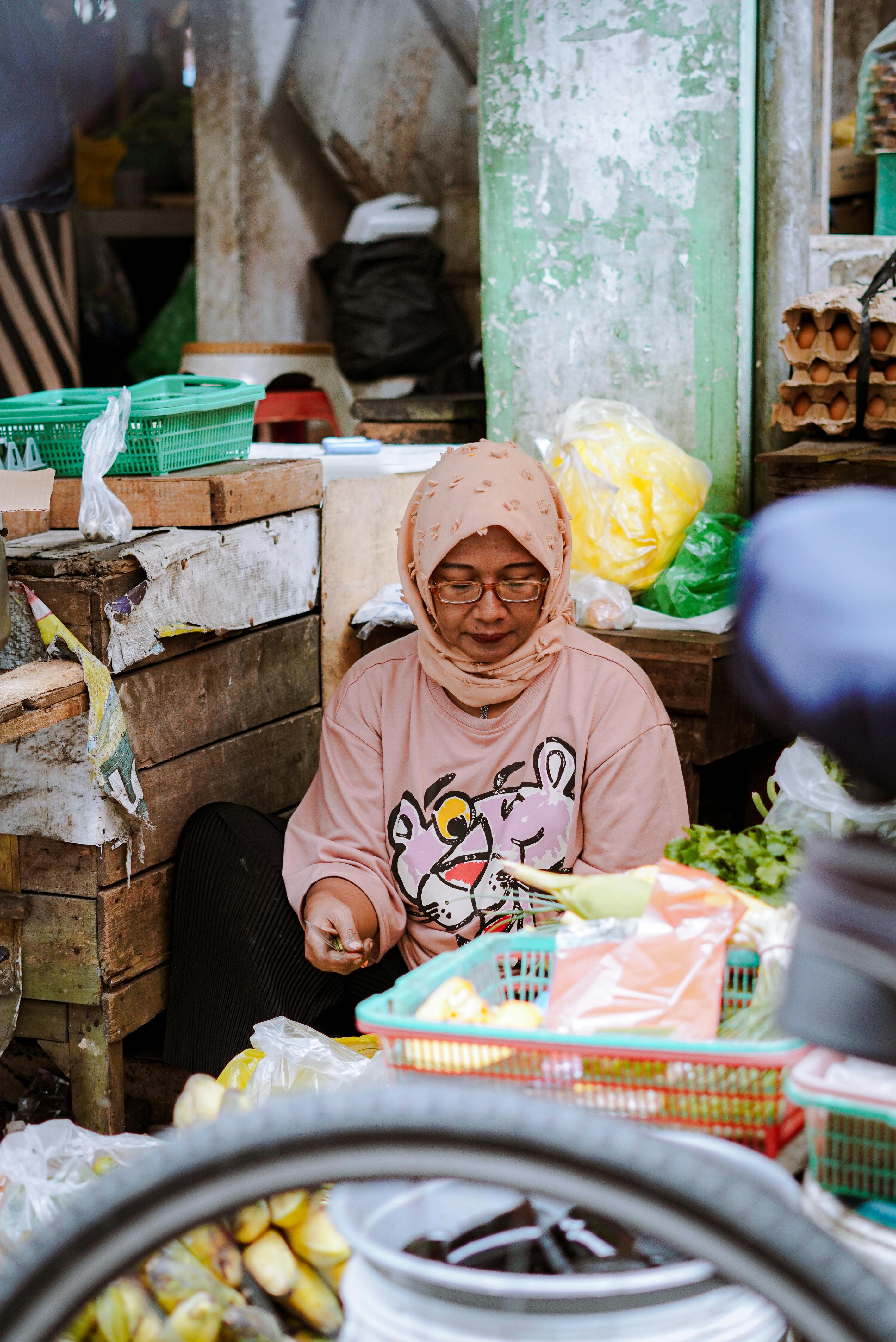 a vendor selling vegetables at a street market