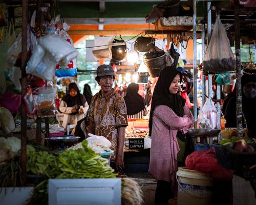 Free Bustling Indonesian market with people shopping for fresh produce. Stock Photo