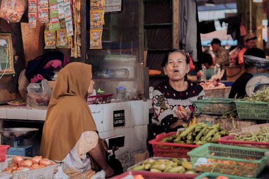 Women selling fresh produce at a busy market in Pontianak, Indonesia.