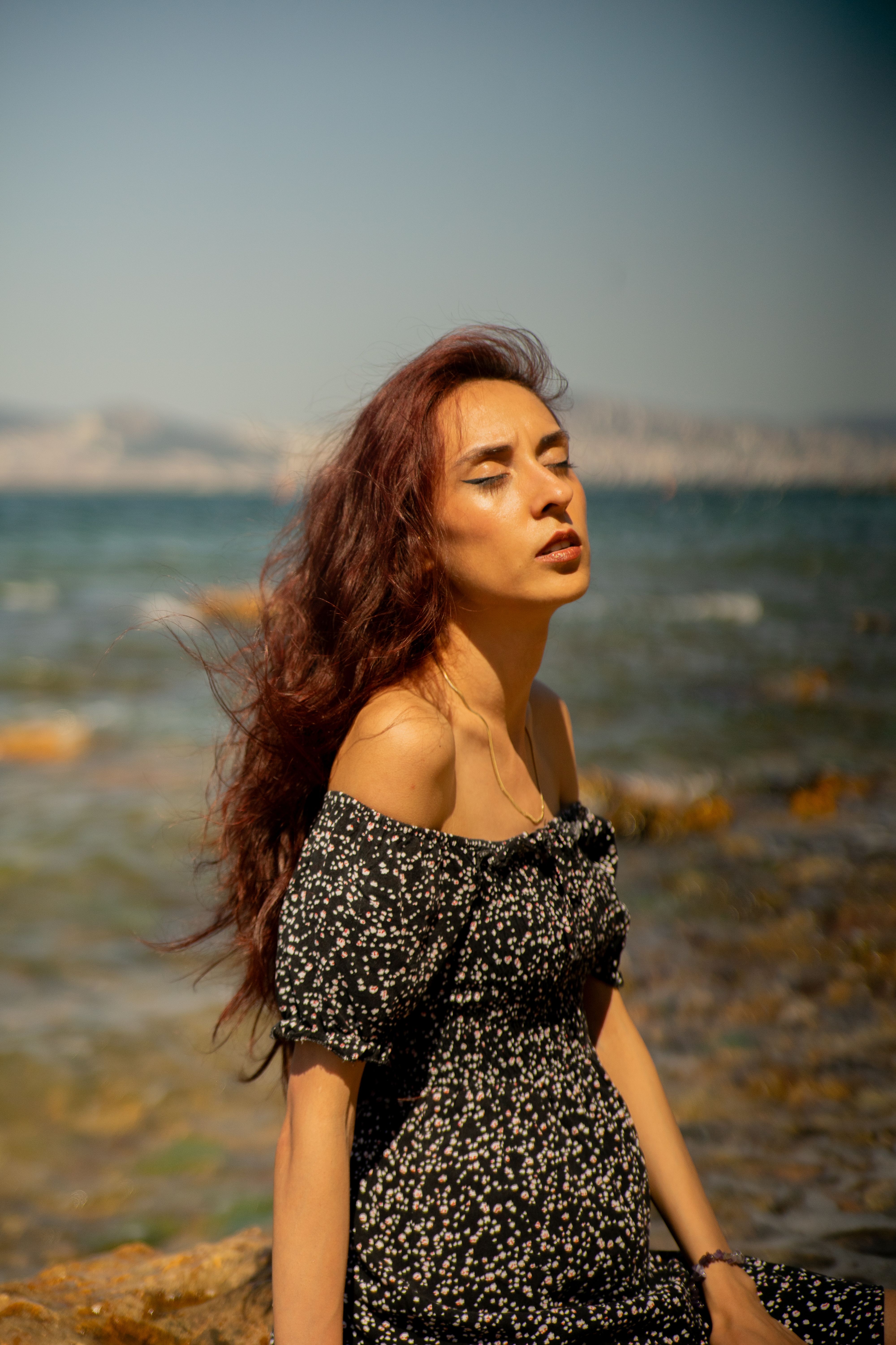 A Woman in a Dress Sitting on the Shore · Free Stock Photo