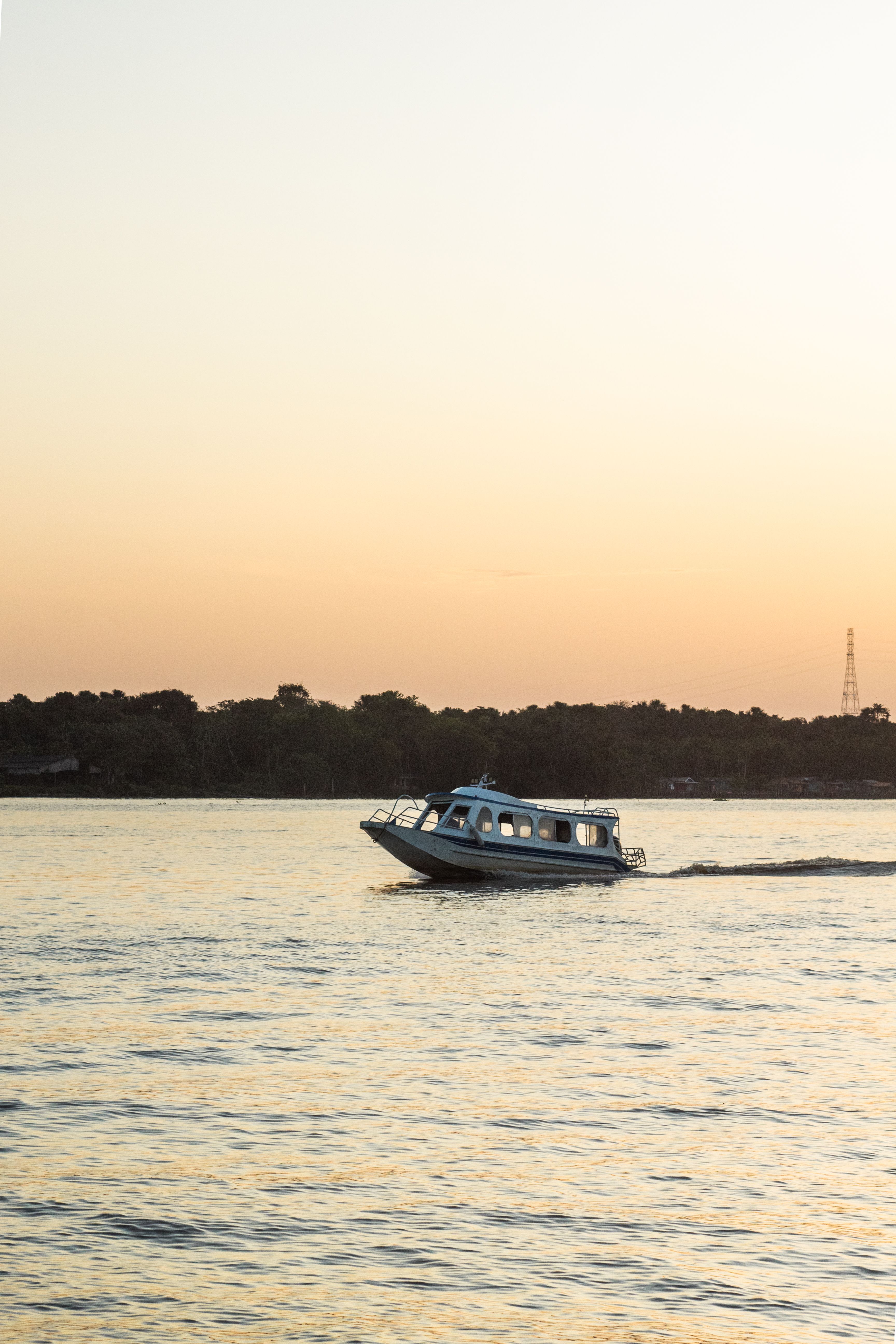 View of a Boat on the Body of Water at Sunset · Free Stock Photo