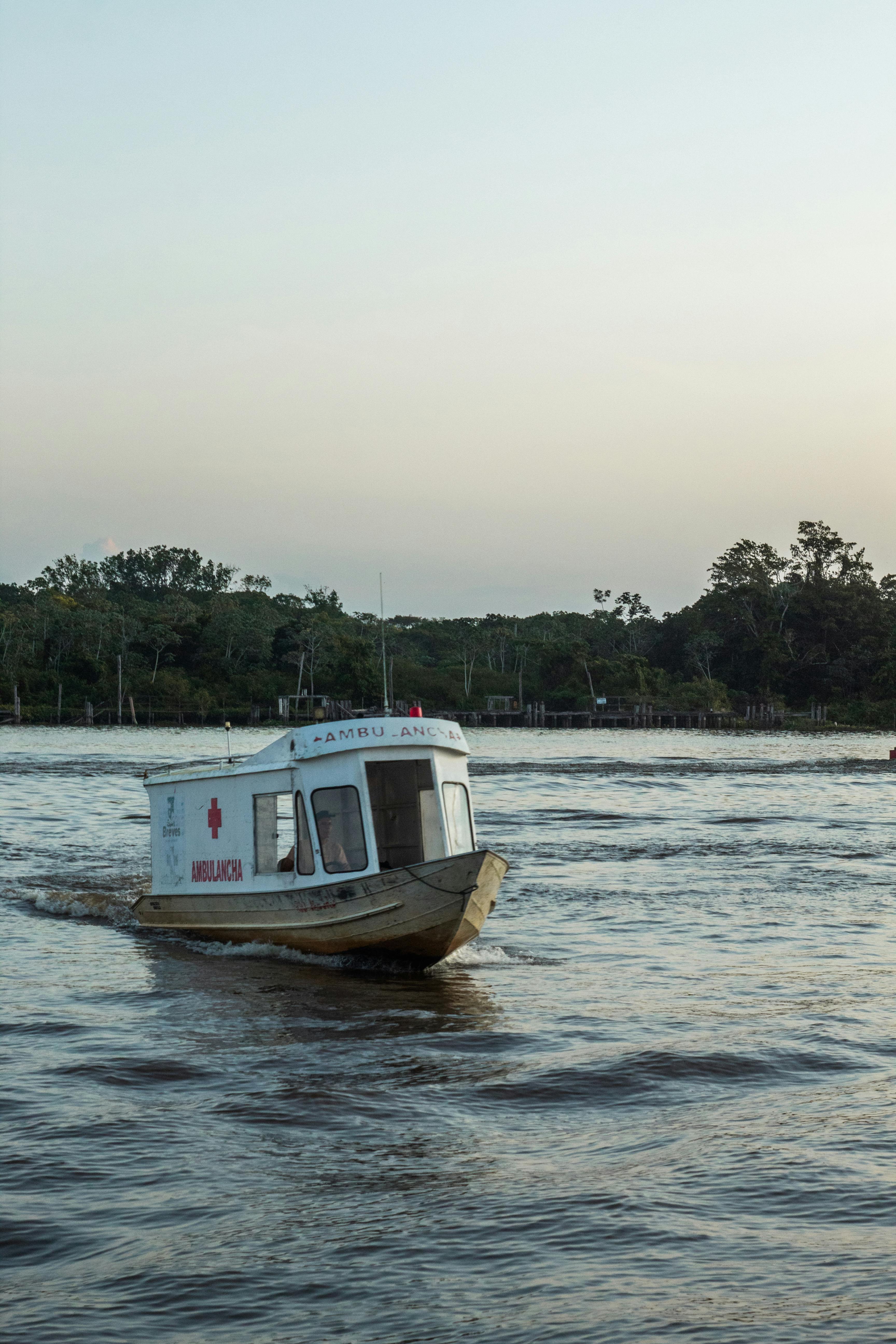 A river ambulance boat on the Amazon, echoing the logistical reality of repeated medical visits in remote communities.
