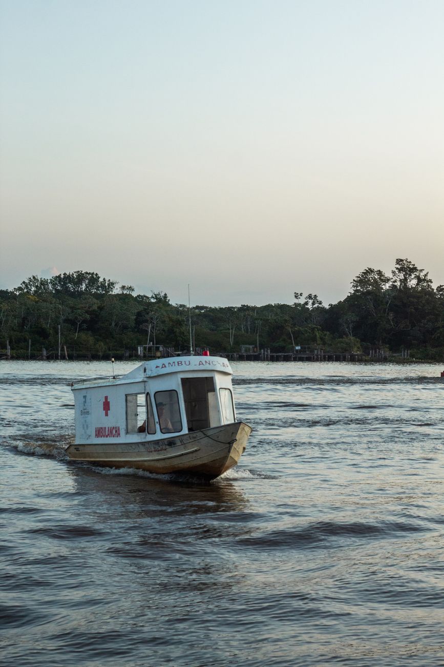 A river ambulance boat on the Amazon, echoing the logistical reality of repeated medical visits in remote communities.