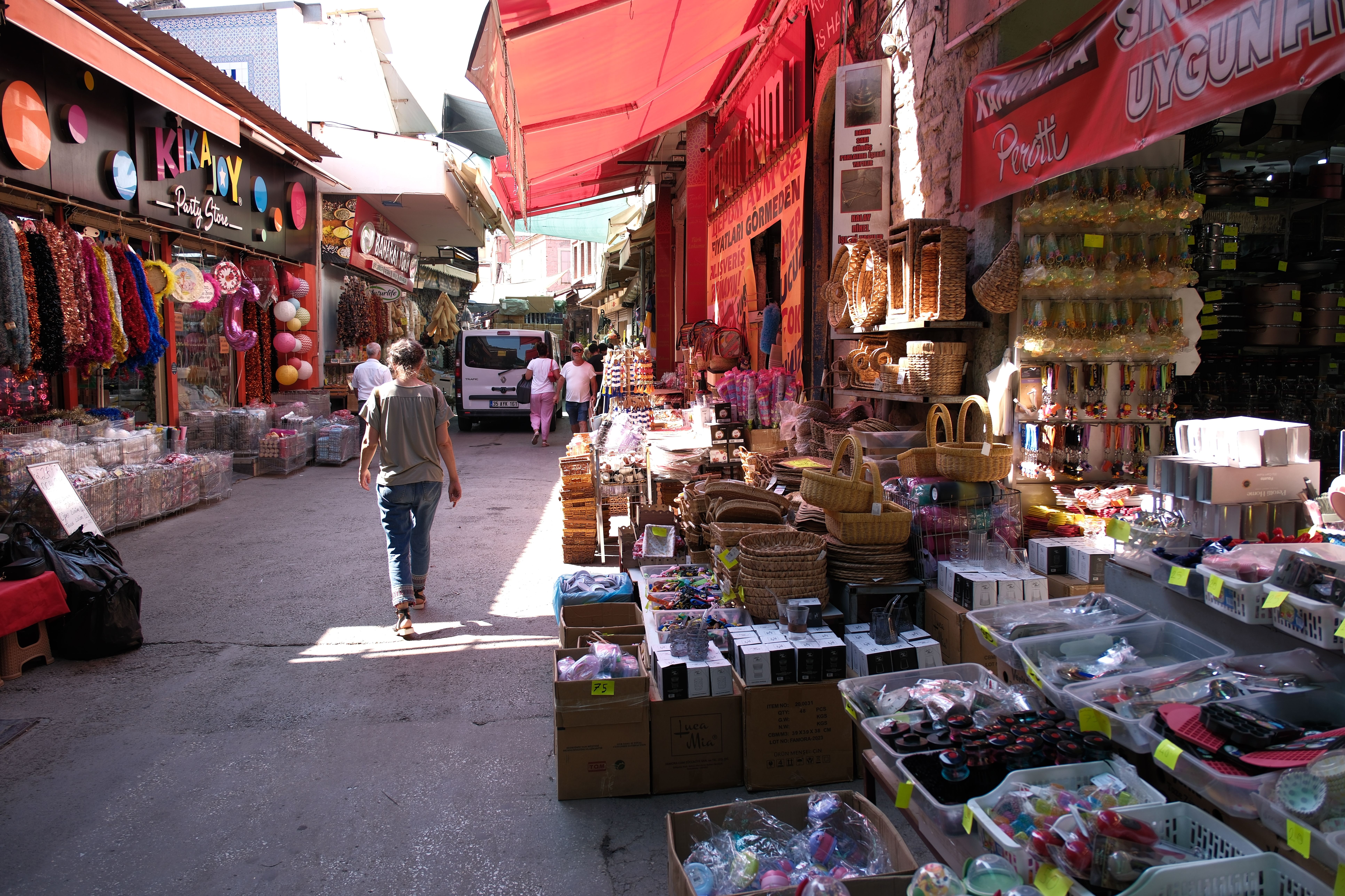 Back View of a Tourist Walking Past a Bazaar · Free Stock Photo